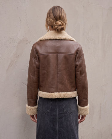 The Cerys Fur Collar Jacket in coffee — faux-leather jacket with faux fur collar, back view on model