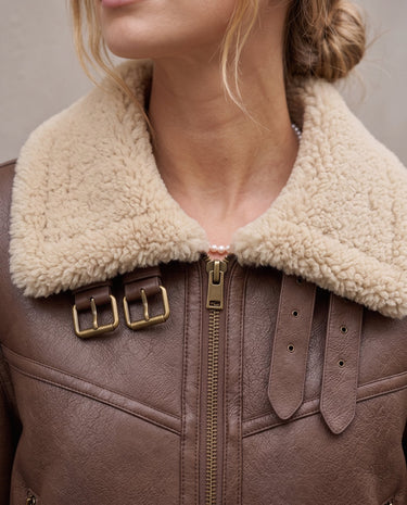 The Cerys Fur Collar Jacket in coffee — close-up of faux fur collar, zip and buckle strap