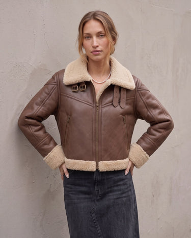 The Cerys Fur Collar Jacket in coffee — faux-leather jacket with faux fur collar, front view on model
