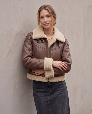 The Cerys Fur Collar Jacket in coffee — faux-leather jacket with faux fur collar, front view on model