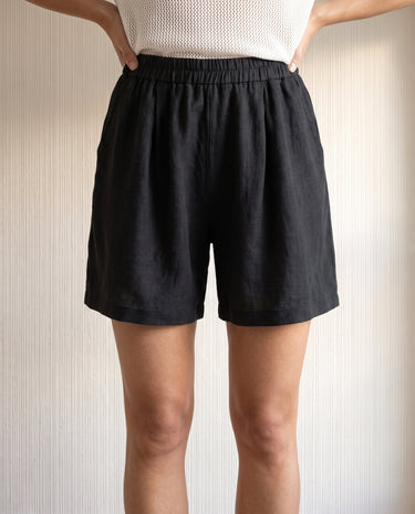 The Ciente Cotton Shorts in black — elastic-waist cotton shorts, front view on model