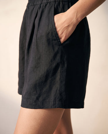 The Ciente Cotton Shorts in black — close-up of side pocket and elastic waist