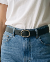 The Cotton Everyday Tee in white — close-up of the tee front tucked at the waist