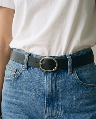 The Cotton Everyday Tee in white — close-up of the tee front tucked at the waist
