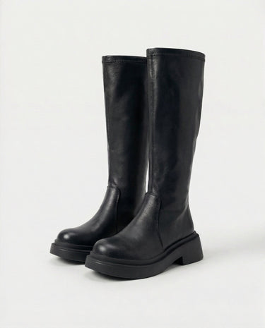 The Elara Slim Riding Boots in black — knee-high riding boots, side view