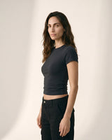 Model wearing black cropped crew-neck tee, three-quarter side view – Moriel Heritage