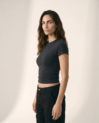 Model wearing black cropped crew-neck tee, three-quarter side view – Moriel Heritage