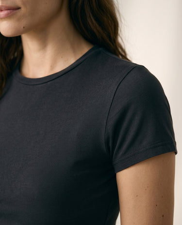 Close-up of black cropped crew-neck tee showing neckline and short sleeve – Moriel Heritage