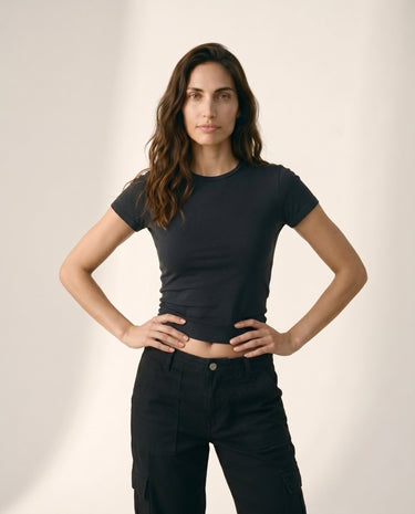 Model wearing black cropped crew-neck tee, hands on hips front view – Moriel Heritage