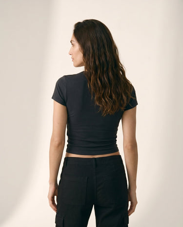 Model wearing black cropped crew-neck tee, back view – Moriel Heritage