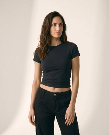 Model wearing black cropped crew-neck tee with black cargo trousers, full-length front view – Moriel Heritage