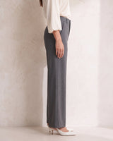 The Elin Wide Leg Tailored Pants in dark gray — wide-leg suit trousers, side view on model