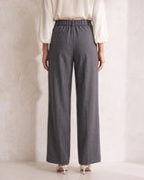 The Elin Wide Leg Tailored Pants in dark gray — wide-leg suit trousers, back view on model