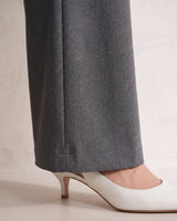The Elin Wide Leg Tailored Pants in dark gray — close-up of wide-leg hem and drape