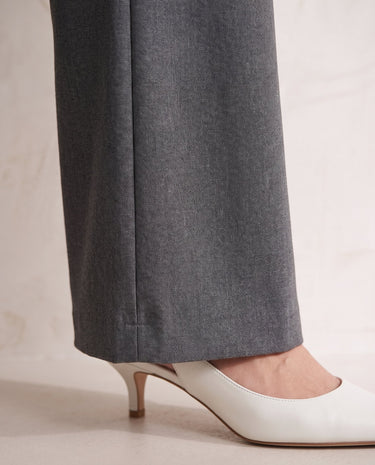The Elin Wide Leg Tailored Pants in dark gray — close-up of wide-leg hem and drape