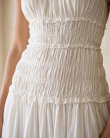 The Elire Dress in white — close-up of shirred tiered bodice detail