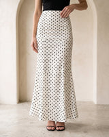 The Elisia Polka Dot Skirt in white — polka dot fishtail maxi skirt, front view on model