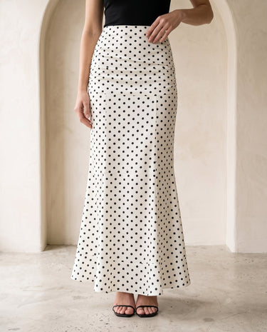 The Elisia Polka Dot Skirt in white — polka dot fishtail maxi skirt, front view on model