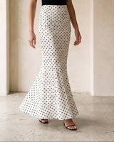 The Elisia Polka Dot Skirt in white — polka dot fishtail maxi skirt, full-length front view on model