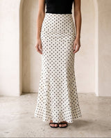 The Elisia Polka Dot Skirt in white — polka dot fishtail maxi skirt, front styling view on model