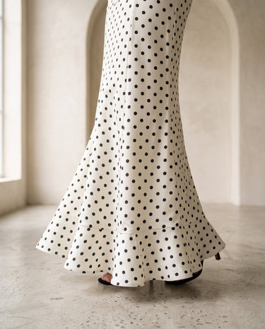 The Elisia Polka Dot Skirt in white — close-up of flared fishtail hem and polka dot print