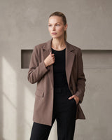 The Elle Blazer in brown — front three-quarter view on model