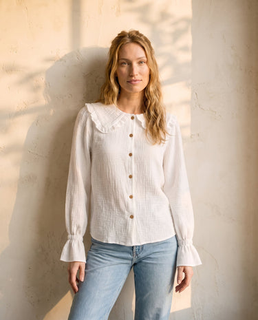 The Elodie Cotton Ruffle Collar Blouse in white — ruffle-collar long-sleeve blouse, front view on model