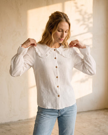 The Elodie Cotton Ruffle Collar Blouse in white — oversized ruffle-collar blouse, front view on model