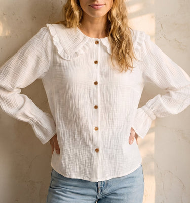 The Elodie Cotton Ruffle Collar Blouse in white — ruffle-collar long-sleeve blouse, front styling view on model
