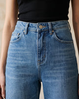 The Elodie jeans in blue — close-up of the high waist and front pockets