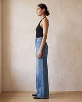 The Elodie jeans in blue — side profile view on model