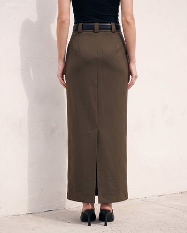 The Eloise Tailored Skirt in brown — straight maxi skirt with back slit, back view on model