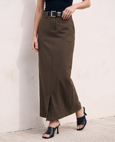 The Eloise Tailored Skirt in brown — straight maxi skirt, side view on model