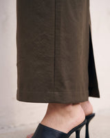 The Eloise Tailored Skirt in brown — close-up of front slit and hem