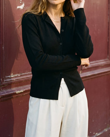 The Elsa Cardi in black — front three-quarter view on model