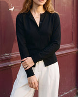 The Elsa Cardi in black — front three-quarter view on model