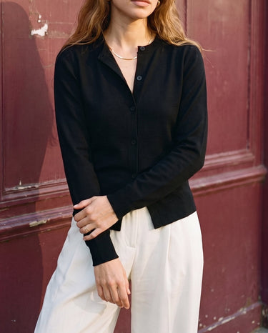 The Elsa Cardi in black — front three-quarter view on model