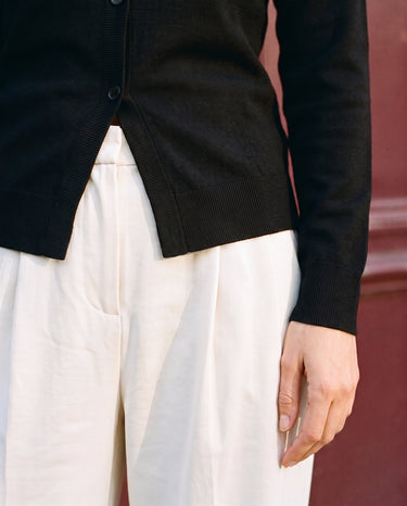 The Elsa Cardi in black — close-up of the ribbed hem and open front