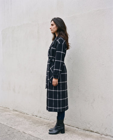 The Emilia Grid Longline Coat in black windowpane check — longline coat, side view on model