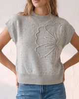 The Floral Embroider Top in light gray — mock-neck knit top with floral embroidery, front view on model