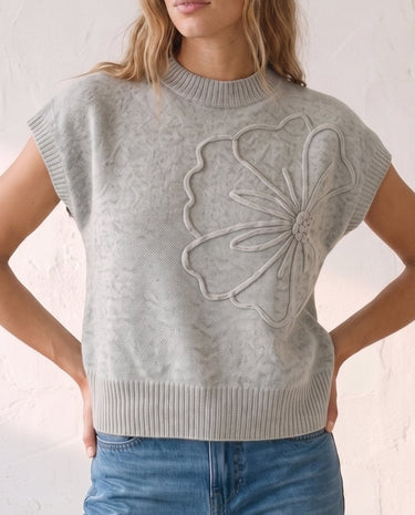 The Floral Embroider Top in light gray — mock-neck knit top with floral embroidery, front view on model