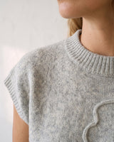 The Floral Embroider Top in light gray — close-up of ribbed mock neckline and shoulder