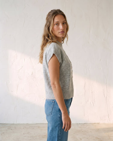 The Floral Embroider Top in light gray — mock-neck knit top, side view on model