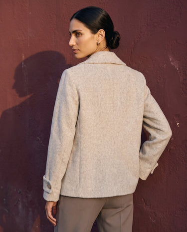 The Georgia Wool Coat in beige — double-breasted coat, back view on model