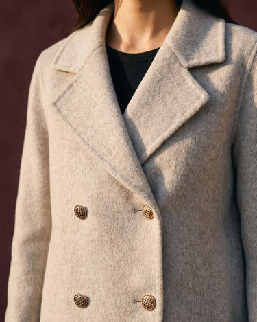 The Georgia Wool Coat in beige — close-up of the notch collar and double-breasted buttons