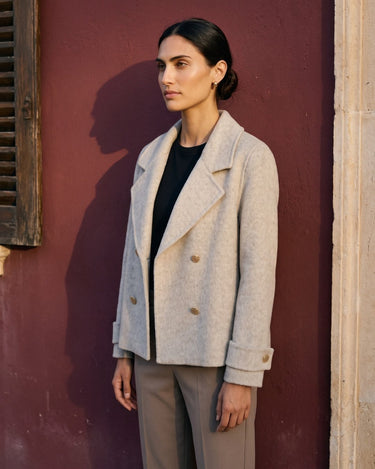 The Georgia Wool Coat in beige — double-breasted coat, side view on model