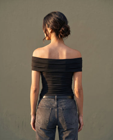 Model wearing black off-shoulder top, back view – Moriel Heritage