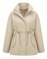 The Halden Coat in light khaki, flat lay front view of the hooded utility jacket with drawstring waist and welt pockets