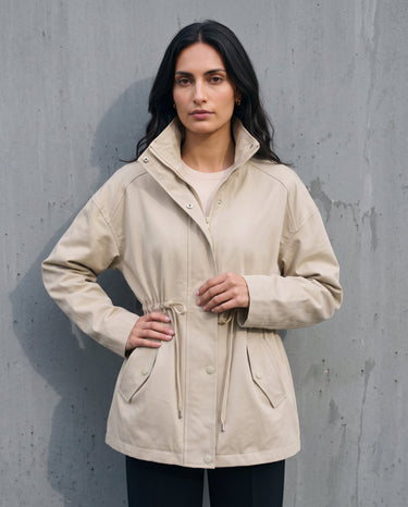 Model wearing the light khaki Halden Coat open, three-quarter front view