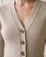 The Harlow Cardi in khaki — close-up of the V-neckline, buttons and ribbed bodice